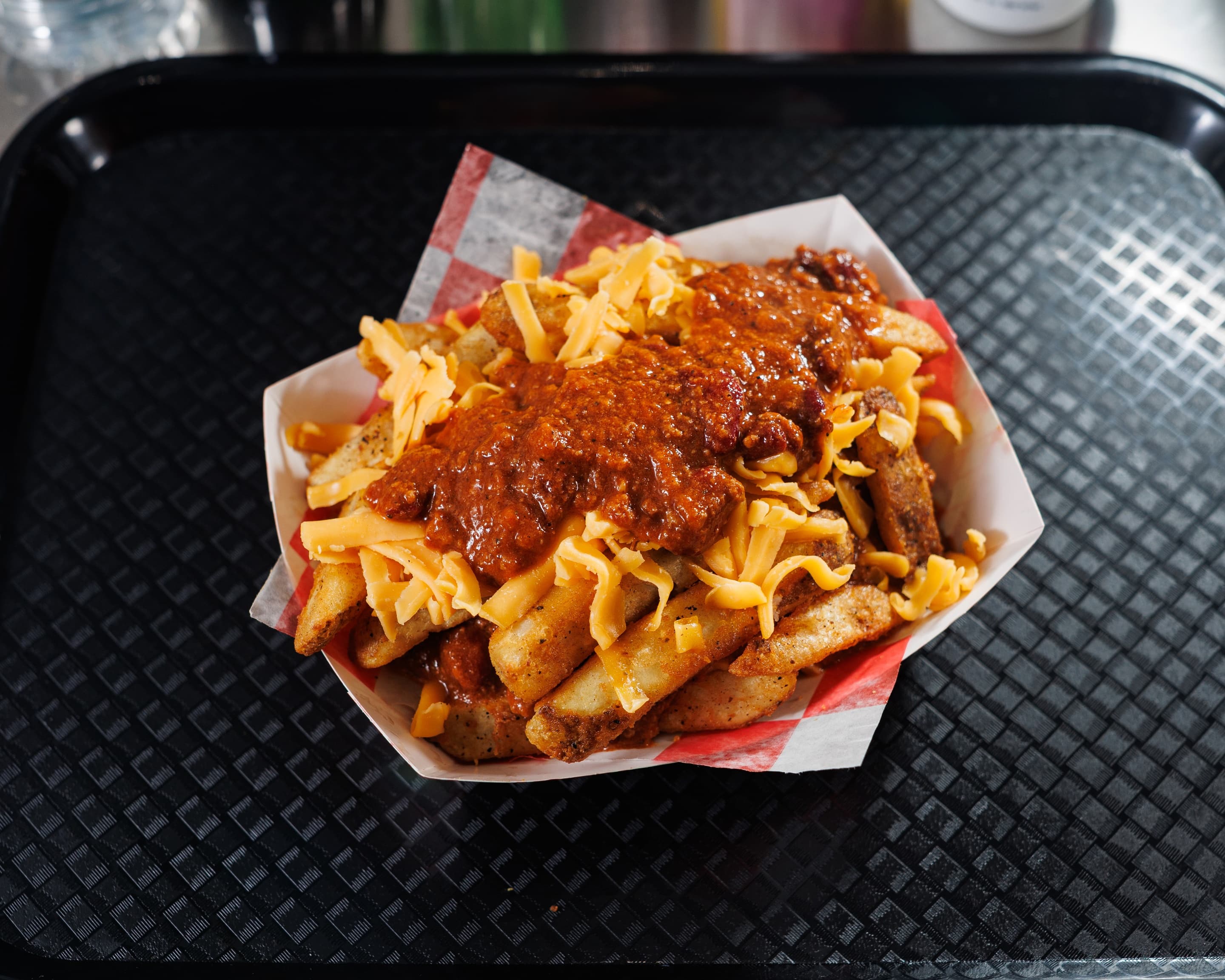Loaded chili cheese fries with shredded cheddar and beefy chili